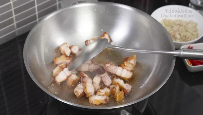 Add garlic to the pan and stir-fry until fragrant. If there's excess oil from the pork, remove some.