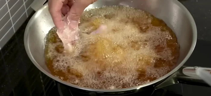Carefully add the fish to the hot oil, spreading them out to prevent sticking. Fry until golden brown and crispy, adjusting heat as needed (medium-high heat recommended).