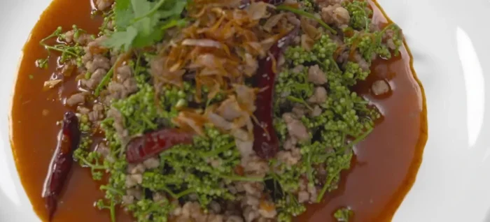 Garnish and serve. Garnish with coriander and additional fried chilies (optional) for added spice and aroma.
