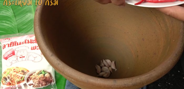 Pound the garlic and Thai chilies together in a mortar and pestle. Adjust chili amount to your spice preference.