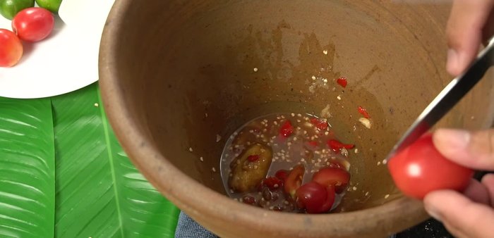 Taste and adjust seasoning (sourness, spiciness, saltiness, sweetness) by adding more lime juice, fish sauce, sugar, or chilies as needed.
