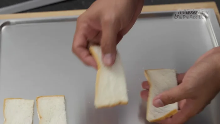Arrange the bread slices neatly on a baking tray. Allow them to air dry or optionally, sun-dry them. Alternatively, you can bake them in the oven to dry them.