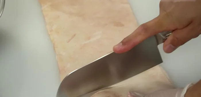 Cut the pig skin into smaller pieces for easier boiling. (Optional: Boil whole if your pot is large enough)