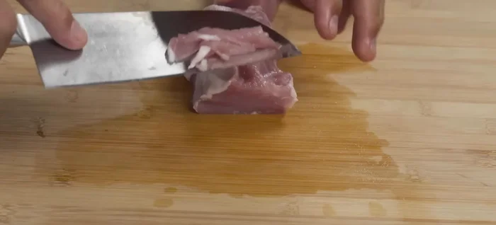 Slice pork against the grain into thin (1-2mm) slices.