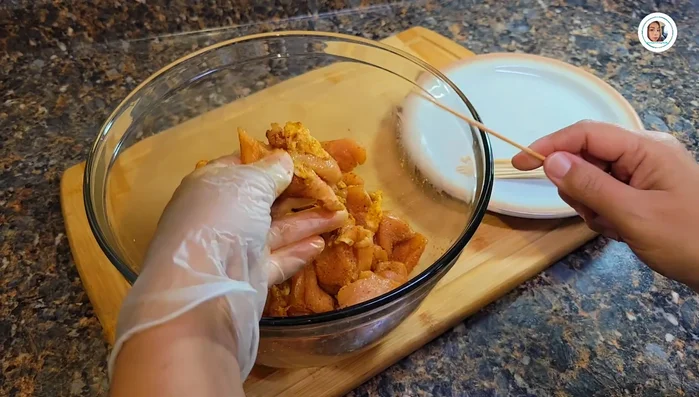Thread marinated chicken onto skewers.