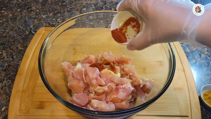 Marinate chicken with paprika powder, ground chili (optional), pepper, salt, turmeric, garlic powder, and curry powder. Mix well and set aside for 30 minutes.