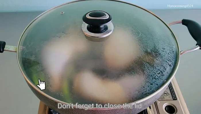 Add the chicken thighs to the boiling mixture. Boil for 20-30 minutes with the lid closed, flipping halfway through and basting with the sauce.