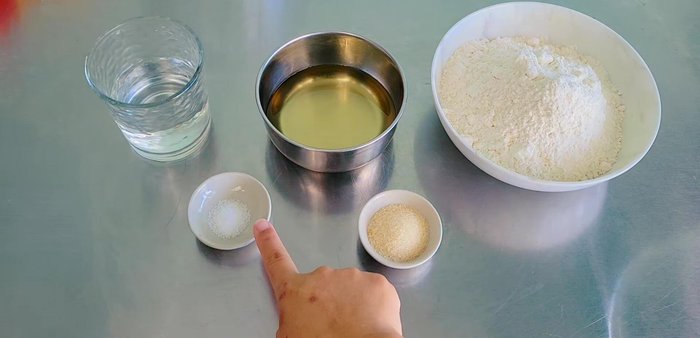 Prepare Outer Dough: Combine flour, sugar, baking powder, oil, and water. Knead into a smooth dough. Let it rest for 15 minutes.