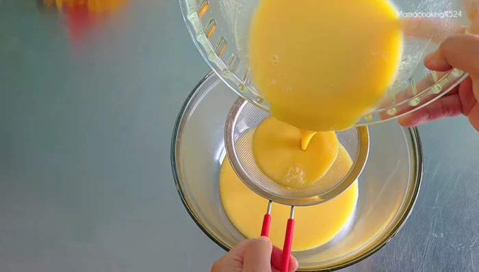 Strain the egg mixture through a fine-mesh sieve or thin cloth to remove any lumps or foam.