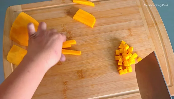 Peel and cut the pumpkin into small pieces suitable for the cups.