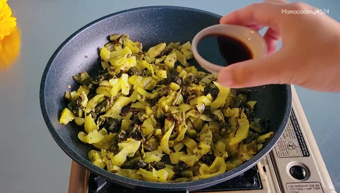 Add pickled cabbage and stir-fry for 5 minutes until softened.