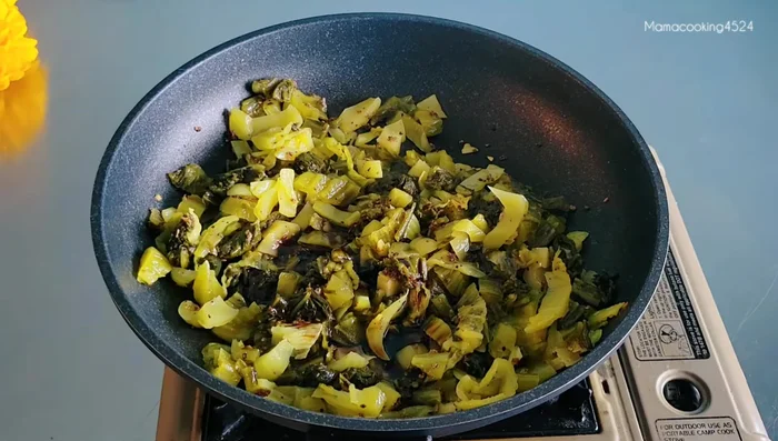 Add white soy sauce, sweet dark soy sauce, oyster sauce, coconut sugar, and Chinese rice wine. Stir-fry until well combined.
