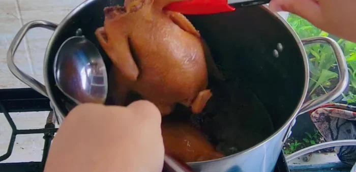 Remove chicken from the pot, shred the meat, and separate the chicken legs and wings.