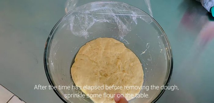 Once rested, sprinkle flour on a surface and gently knead the dough.