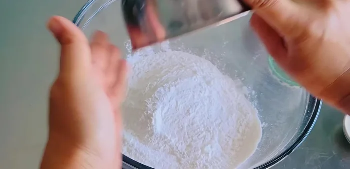 Mix glutinous rice flour, sugar, salt, and gradually add warm fresh milk and oil, mixing until a soft dough forms. Add more flour if needed to prevent sticking.