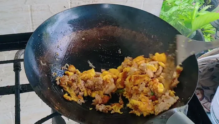 Stir-fry continuously until the eggs become crispy.