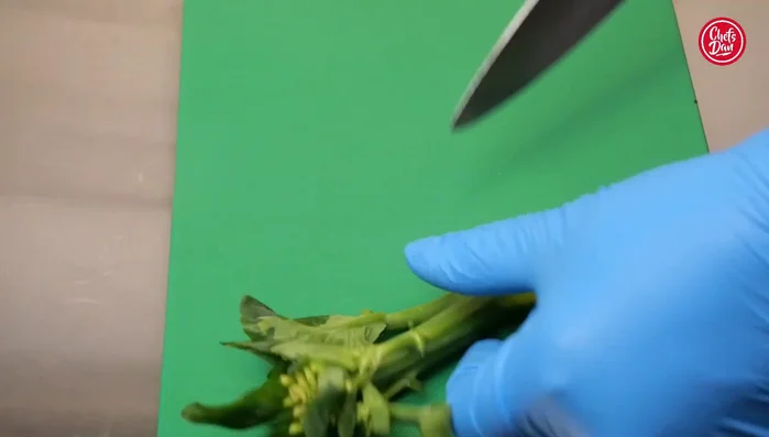 Cut the kale in half lengthwise, focusing on the longer stems.