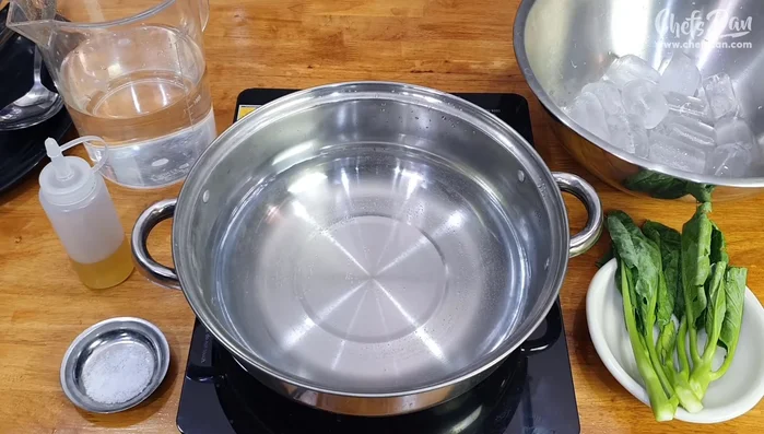 Blanch vegetables: Bring water to a boil with salt and oil. Add vegetables and blanch until bright green. Immediately transfer to an ice bath to retain color and crispness. (461.64, 491.46)