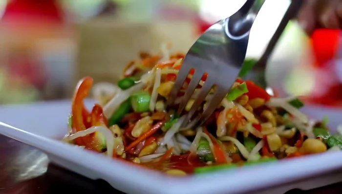 Prepare the Papaya Salad, Grilled Chicken, and Sticky Rice according to your preferred recipes.