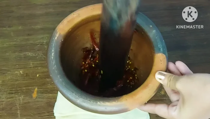 Pound the fried chilies until finely ground. Add the fried garlic and pound until fine.
