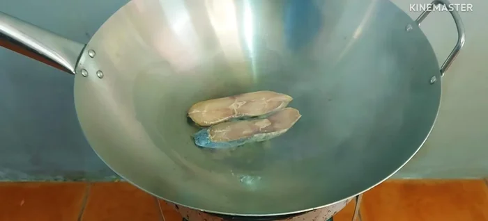 Fry the salted fish in a hot stainless steel pan until golden brown. Remove and let cool.