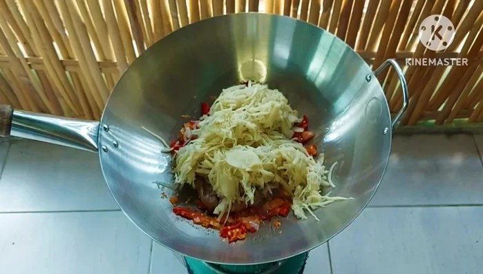 Add the pickled bamboo shoots to the stir-fry. If the mixture is too dry, add a little water.