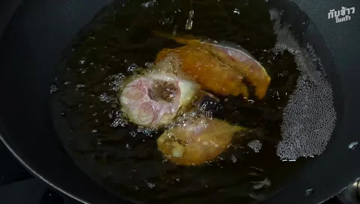 Deep-fry the catfish in hot oil until crispy and golden yellow. Avoid overcrowding the pan; fry in batches if necessary. Use a lid to prevent oil splattering.