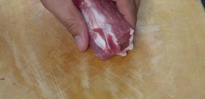 Cut the pork shoulder into thin slices against the grain.