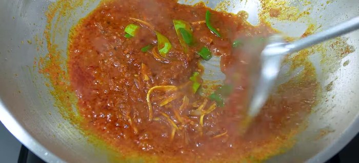 Add sliced galangal and kaffir lime leaves. Stir-fry until cooked.