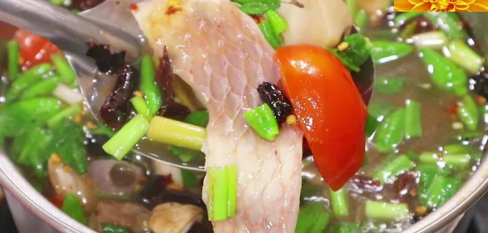 Heat vegetable oil in a pot. Add lemongrass, galangal, and chilies. Sauté until fragrant.