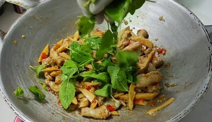 Add basil leaves and stir-fry until wilted and fragrant.