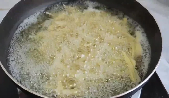 Prepare bamboo shoots: Cut them and boil to remove unpleasant odors. Wash and drain.