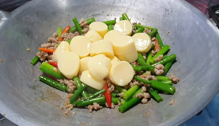 Add egg tofu and stir-fry gently to avoid breaking it.