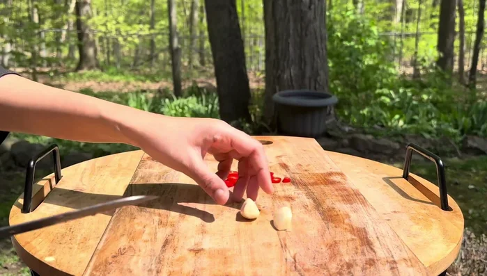 Prepare the dressing: Chop Thai red chili and garlic. Crush them into a fragrant paste using a pestle and mortar.