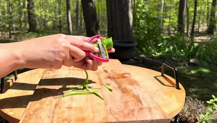 Thinly slice all the vegetables (mango, cucumber, bell pepper, and red onion). A slicing peeler helps achieve even slivers.