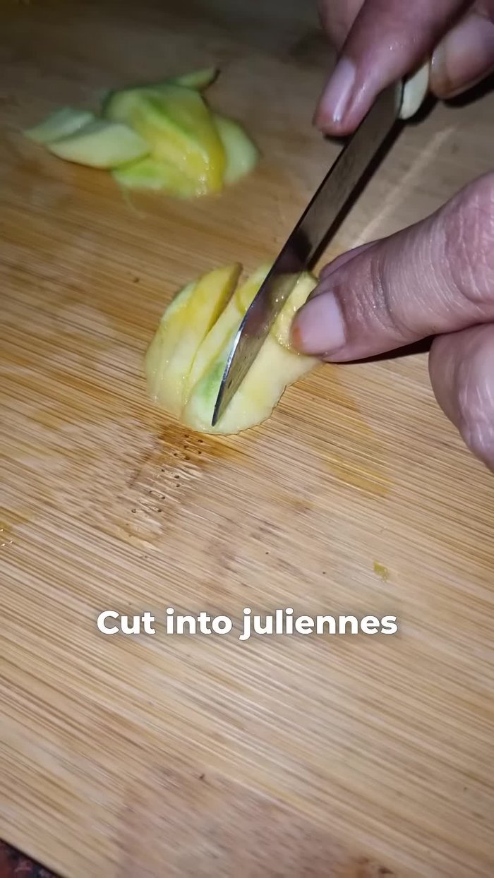 Cut the raw mango into thin juliennes. Chop all vegetables (beetroot, cucumber, onion, optional carrot, cabbage, radish) into long, thin slices.