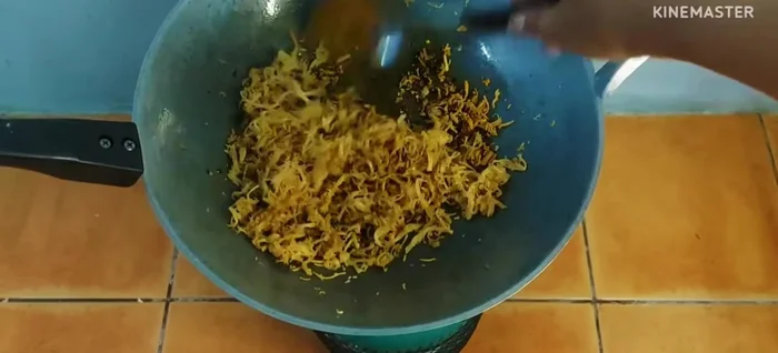 Add turmeric powder, fried chicken, sugar, seasoning powder, MSG, and salt. Stir-fry until well combined and the chicken is coated in the chili paste.