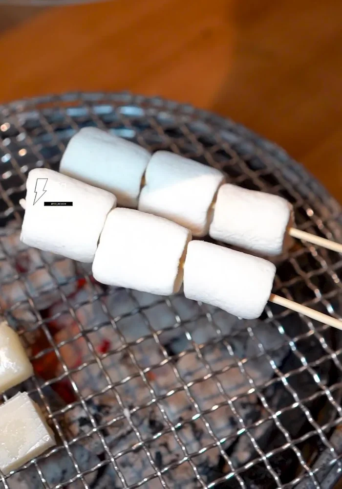 Prepare Marshmallows: Grill the marshmallows until crispy on the outside and soft on the inside. Dip in chocolate sauce. [Note: as mentioned at 154.239]