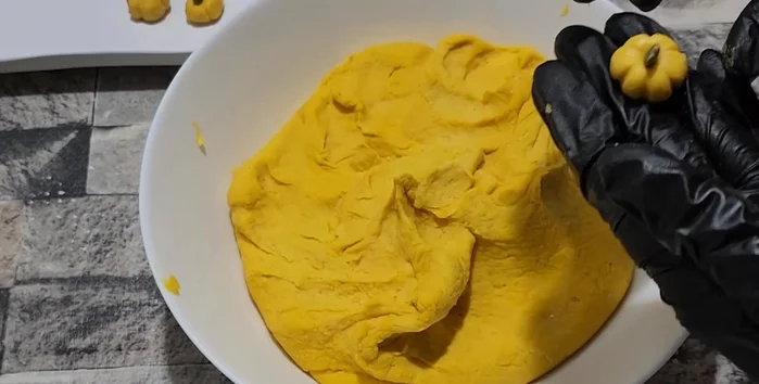 Insert a pumpkin seed into the center of each pumpkin-shaped dumpling.