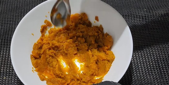 Mash the cooked pumpkin using a spoon.