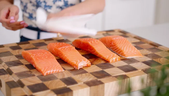 Pat salmon fillets dry with a paper towel and season with salt and pepper.