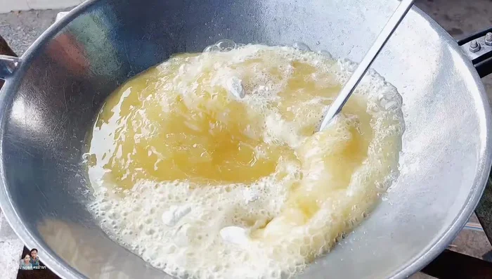 Heat the pan with oil. Add 1 spoon of fried batter to dissolve in the oil. Mix well. This prevents the fish from sticking and reduces oil splattering.