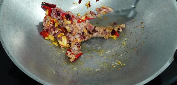 Add minced pork and stir-fry until partially cooked.