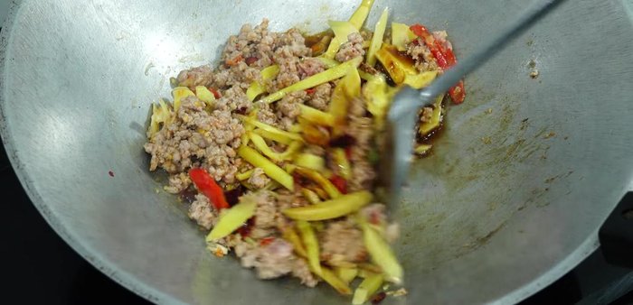 Continue stir-frying until pork is cooked through.