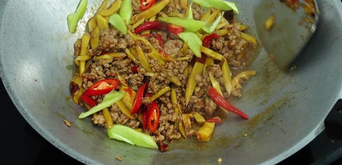 Add red chili, bell pepper, and stir-fry until cooked.