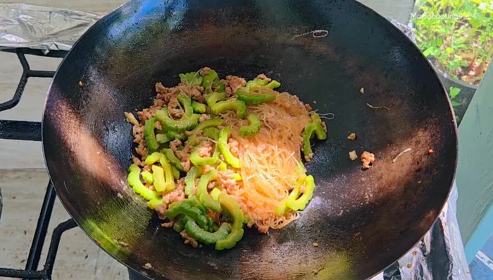 Once the glass noodles are soft, add the cooked eggs. Stir gently to combine everything, ensuring the glass noodles don't stick together.