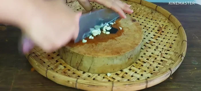 Chop the Chinese garlic (8-10 cloves) and chilies (green and red, for color and flavor).