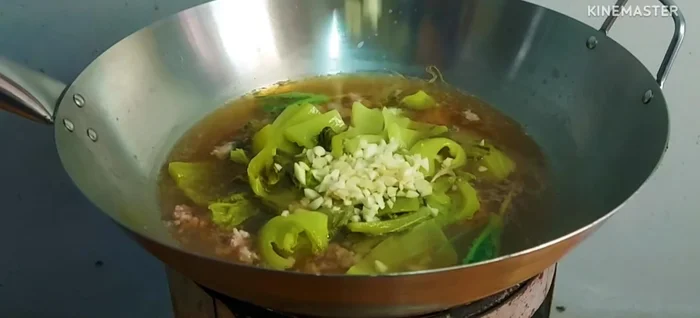 Add chopped chilies and simmer. Taste and adjust seasoning as needed.