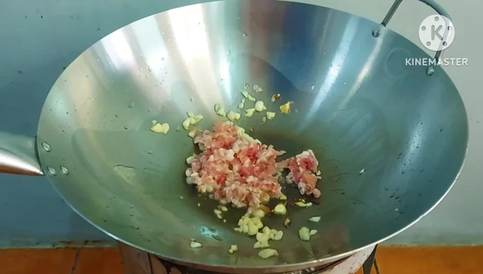 Add minced pork and onion; stir-fry until cooked.