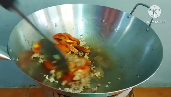 Add stir-fried tomatoes to the pan; cook slightly.